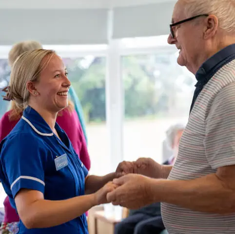 ACI Care | A staff member and resident dancing