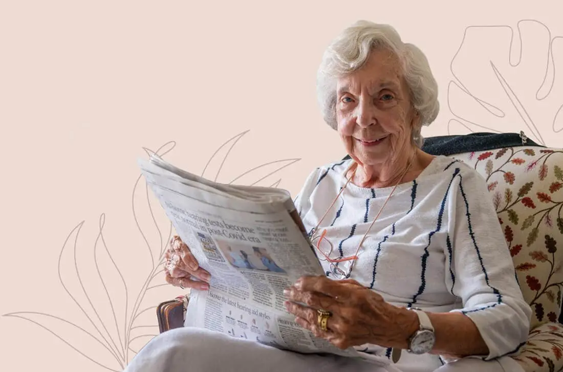 ACI Care | an image of one of our residents reading a newspaper