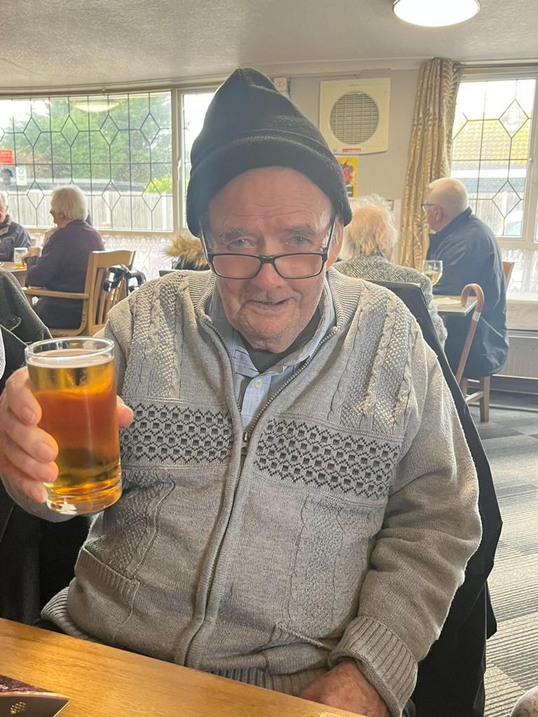 A resident with a pint of beer on an excursion to the pub