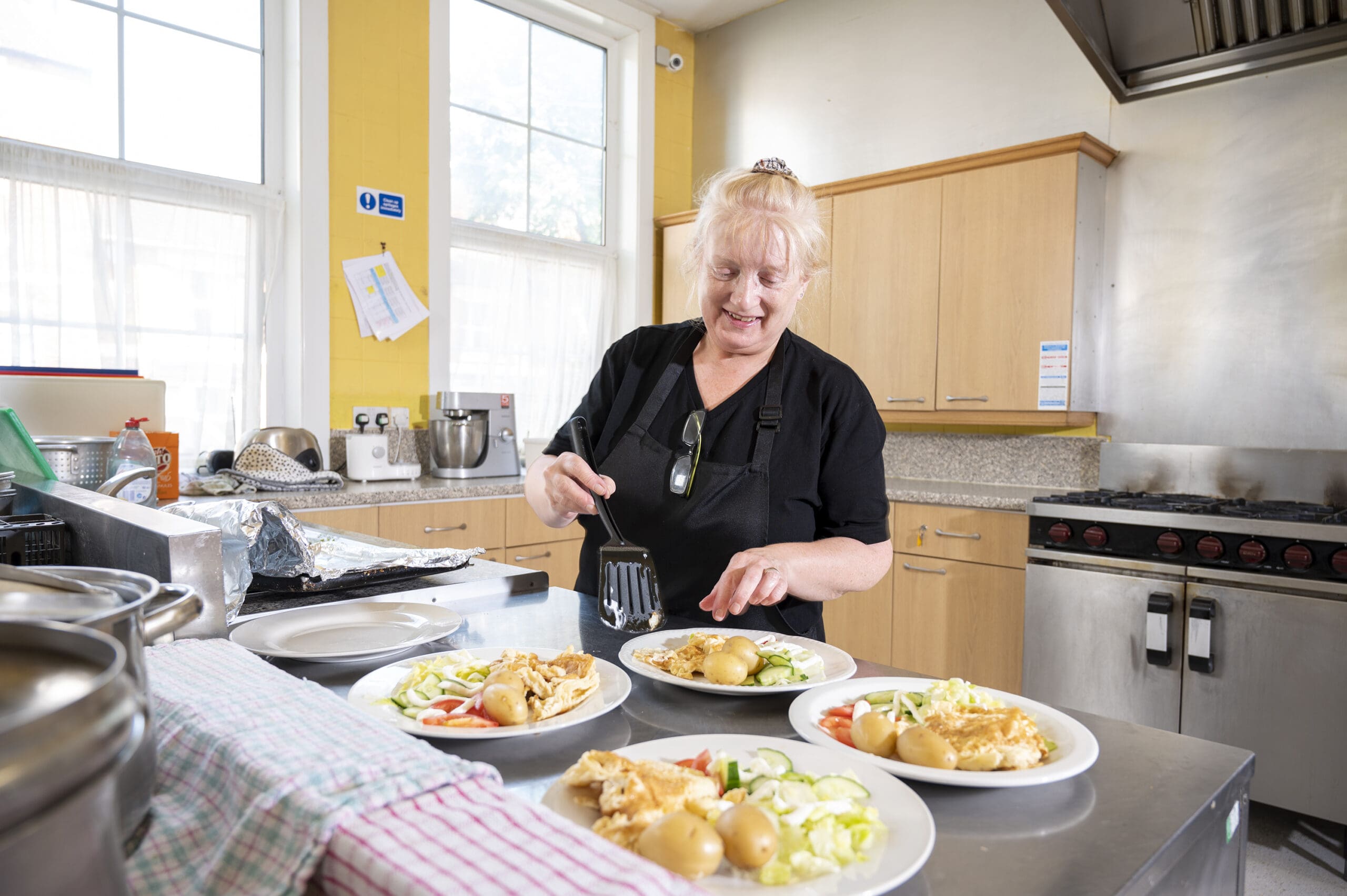 Best Social Activities for the Elderly | Our care worker serving up meals to residents