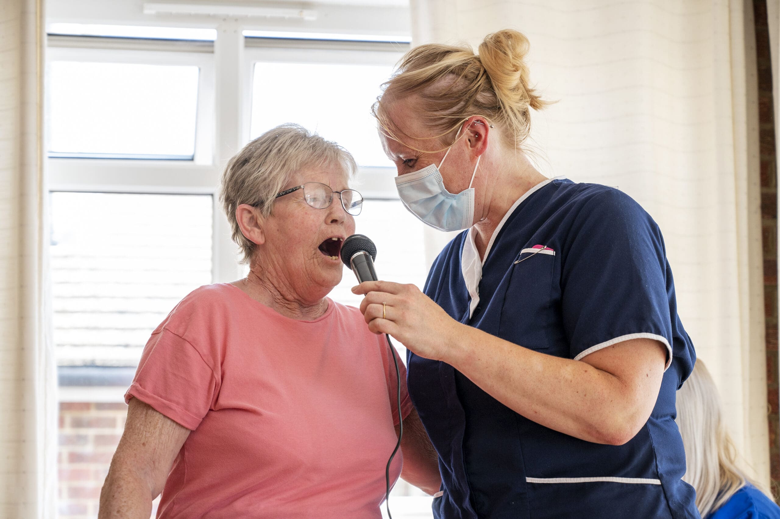Bespoke Care | A resident and care worker singing together