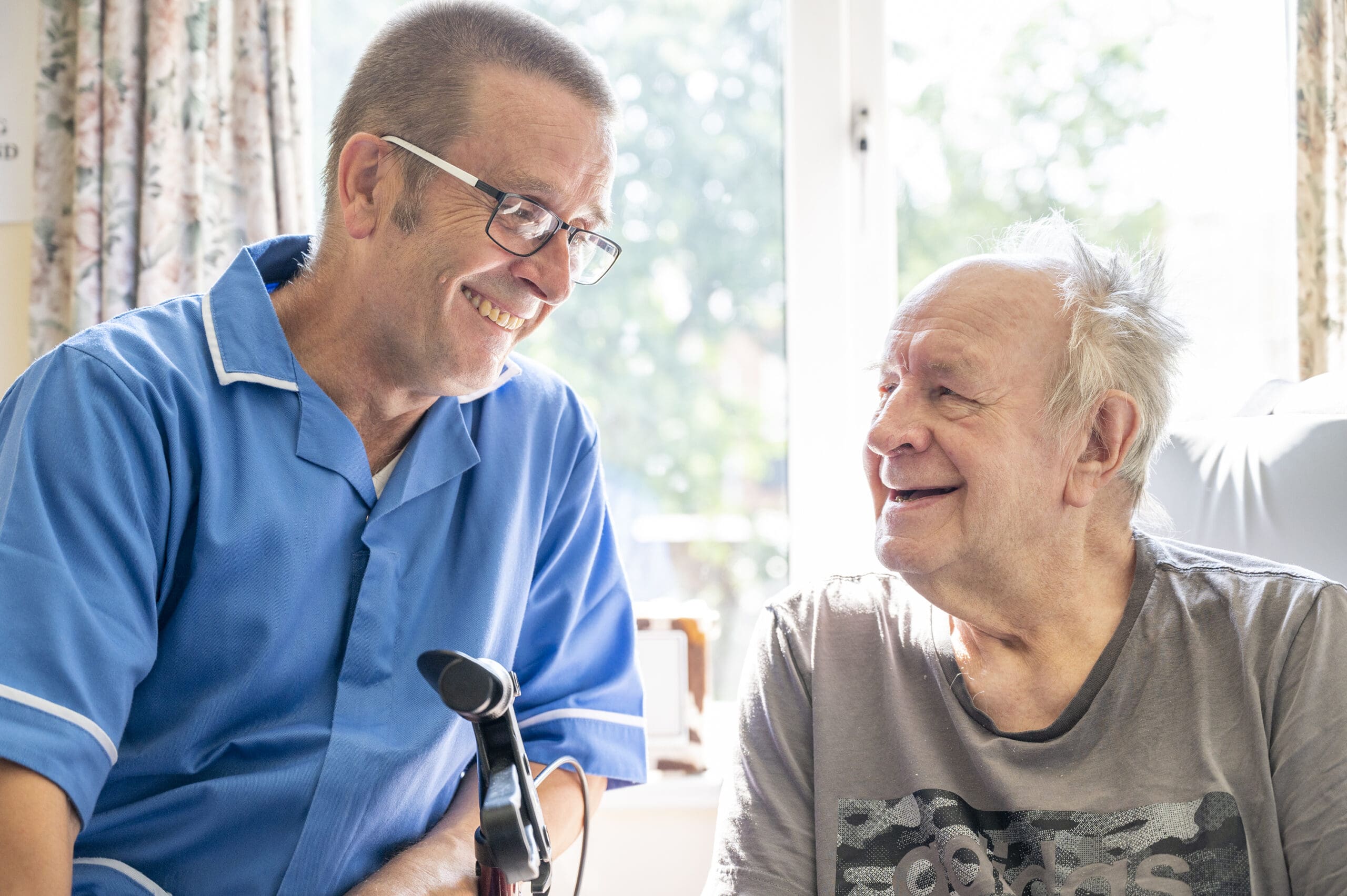 Bespoke Care | A resident and care worker exchanging a smile