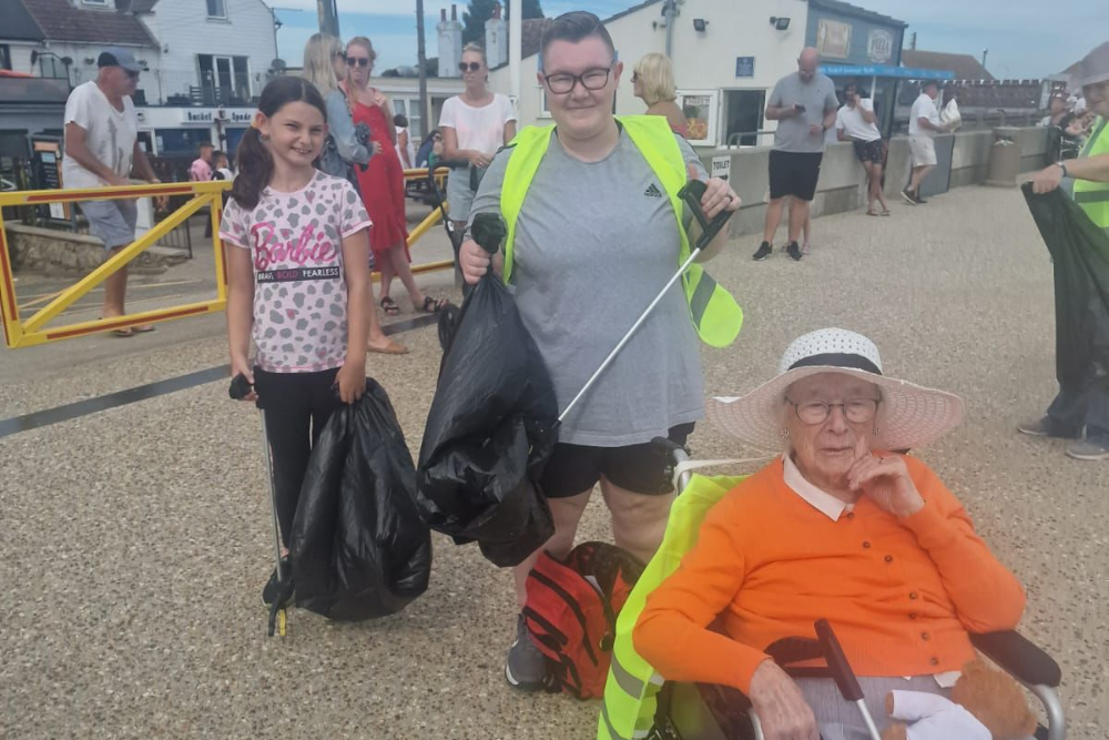 Carer resident and volunteer helping to clean beaches