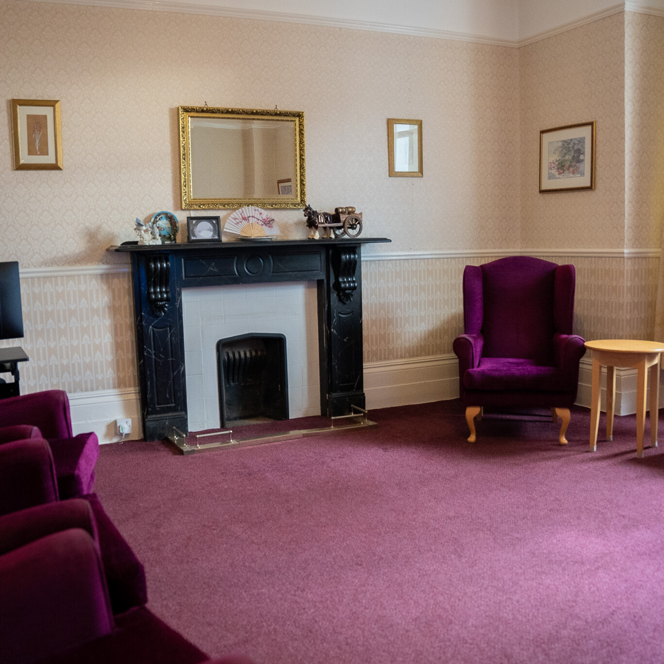 ACI Care | The fireplace in the communal lounge at Mountside Care Home Hastings, creating a warm and cozy gathering space for residents.