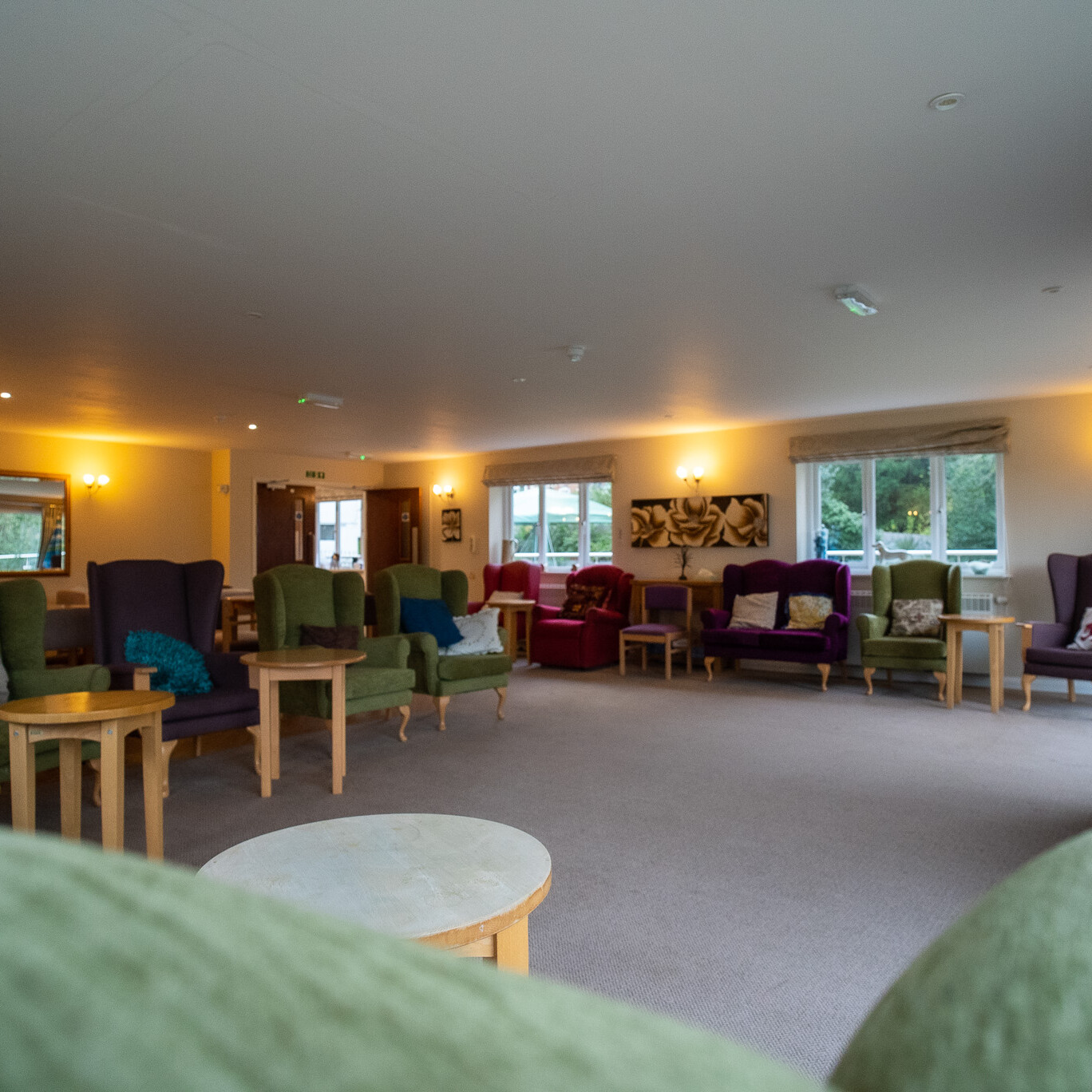 ACI Care | A variety of comfortable furniture in the communal lounge at Mountside Care Home Hastings, creating a warm and inviting space for residents