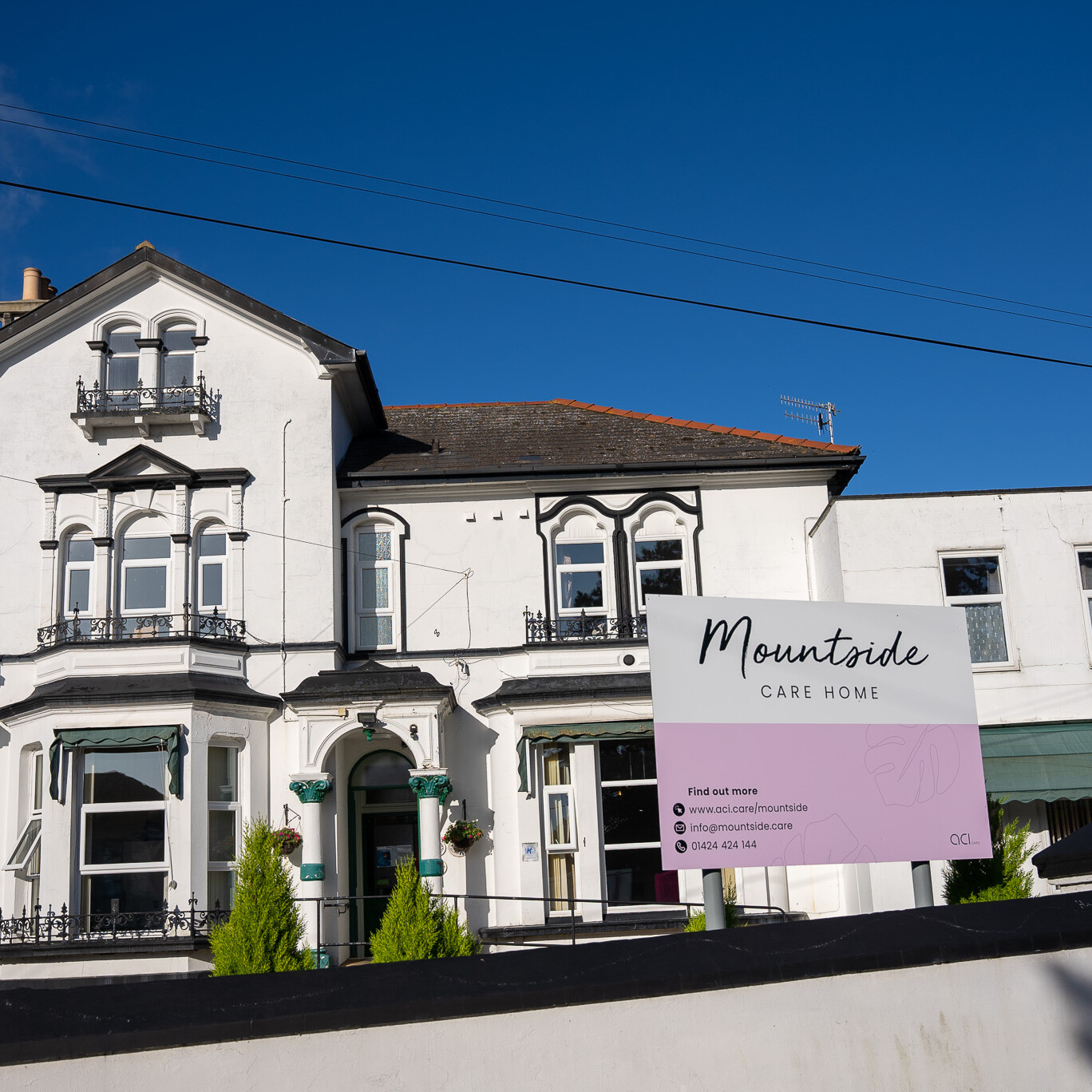 ACI Care | A wide-angle exterior view of Mountside Care Home Hastings, featuring the front signage and welcoming entrance