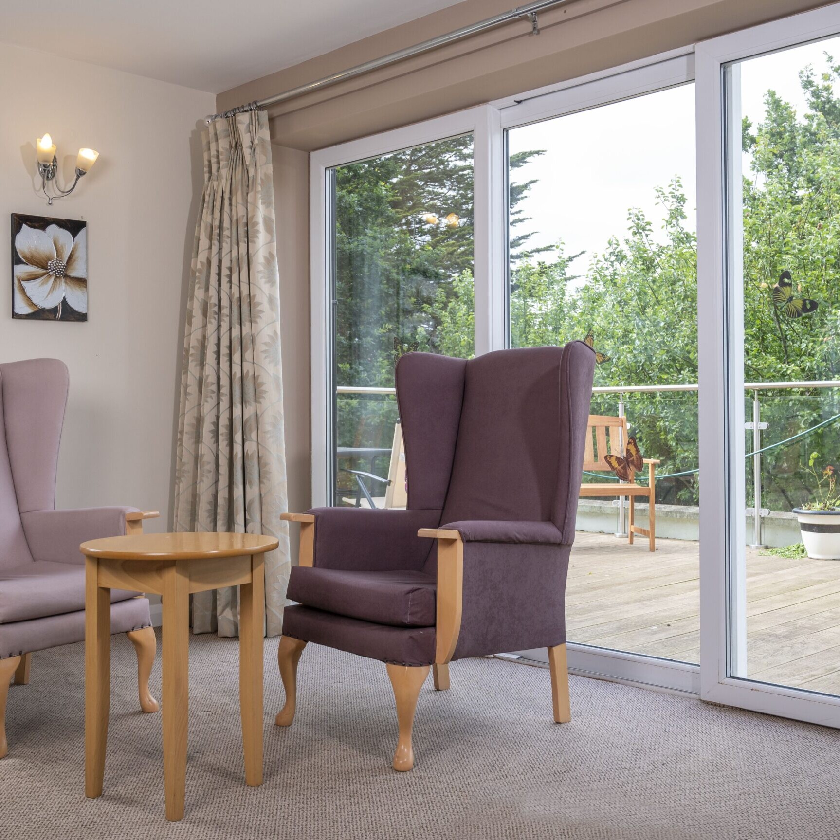 ACI Care | The large double doors at Mountside Care Home Hastings, opening into the bright and inviting conservatory.