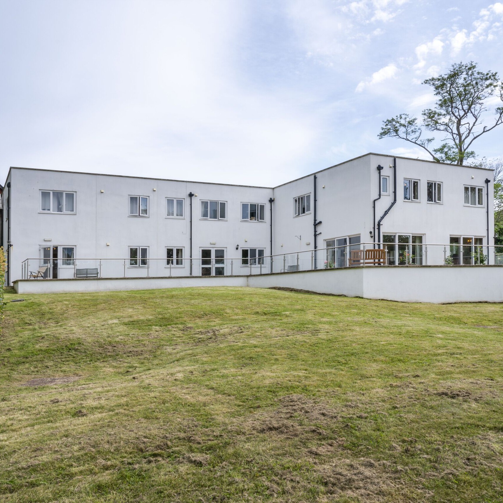 ACI Care | A rear view of Mountside Care Home Hastings, showcasing the building and its outdoor surroundings.